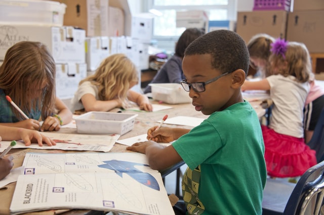 Kids learning in public school classroom